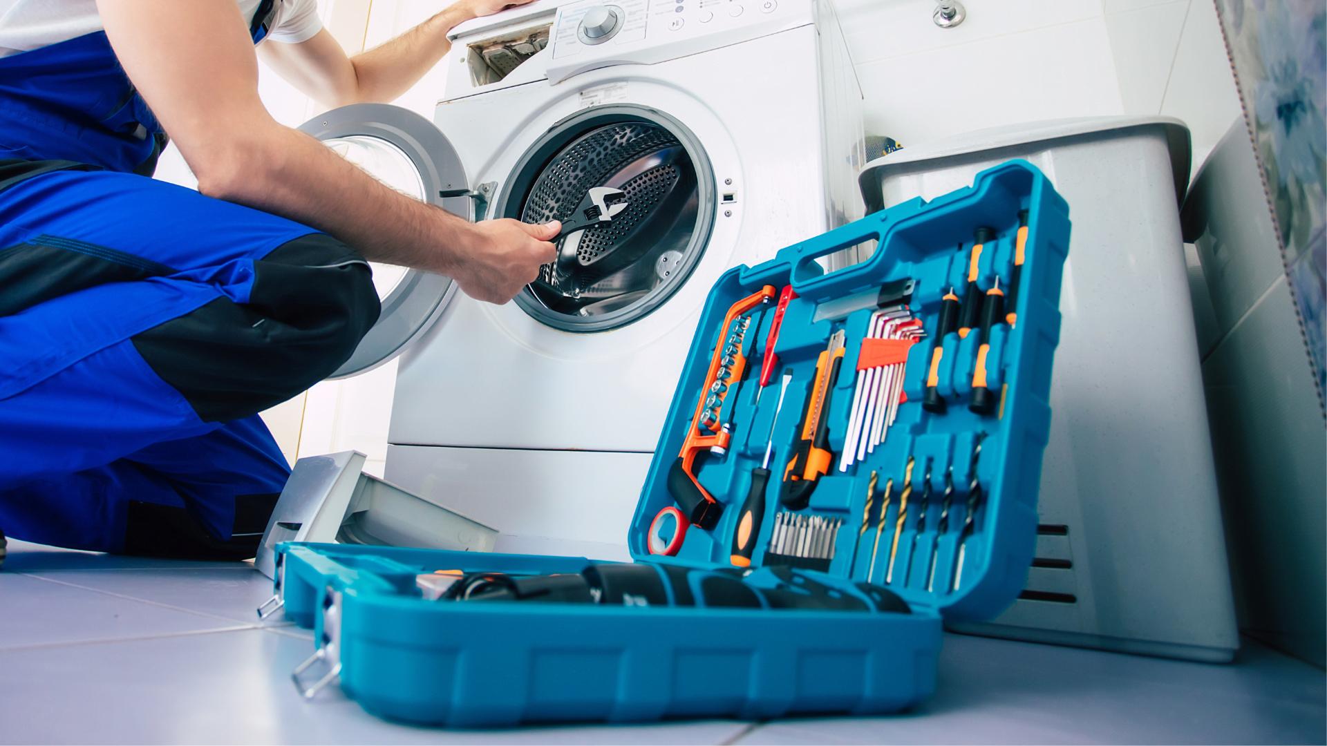 Appliance repair technician working on a washing machine